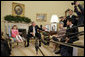 President George W. Bush addresses the press during a meeting with a family of North Korean defectors and family members of Japanese citizens who were abducted by the North Korean government in the Oval Office Friday, April 28, 2006. Kim Han-Mee, the daughter of North Korean defectors, sat next to the President. White House photo by Paul Morse