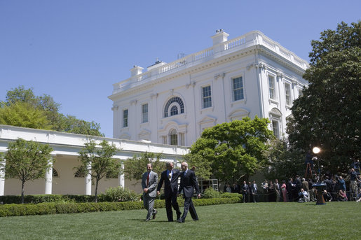 President George W. Bush walks across the Rose Garden with Al Hubbard of the National Economic Council, left, and Ed Lazear of the Council of Economic Advisors, after addressing the press Friday, April 28, 2006. White House photo by Paul Morse