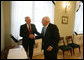 After signing the guest book at the Presidential Palace in Vilnius, Lithuania, Vice President Dick Cheney shakes hands with Lithuanian President Valdus Adamkus, Wednesday May 3, 2006. The two leaders participated in a bilateral meeting to discuss regional issues prior to the beginning of the Vilnius Conference 2006, a summit gathering heads of state from the Baltic and Black Sea regions that begins Thursday. White House photo by David Bohrer