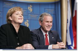 President George W. Bush shares a moment with Chancellor Angela Merkel of the Federal Republic of Germany, during the American Jewish Committee's Centennial Dinner Thursday, May 4, 2006, at the National Building Museum in Washington, D.C.  White House photo by Paul Morse