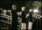 President George W. Bush stands at attention Friday, May 5, 2006, during an Evening Parade at the Marine Barracks in Washington, D.C. The President and Mrs. Laura Bush spent the evening meeting with U.S. Marine Corps Noncommissioned Officers of the Year and wounded Marines. White House photo by Paul Morse