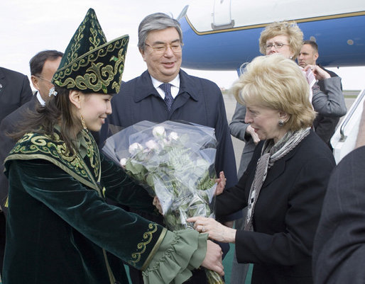 A Kazakh woman adorned in ceremonial dress welcomes Mrs. Lynne Cheney to Astana, Kazakhstan, with a bouquet of flowers, Friday, May 5, 2006. White House photo by David Bohrer