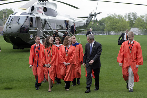 President George W. Bush walks with graduates after arriving at Oklahoma State University in Stillwater, OK where he delivered the commencement address to the class of 2006 on Saturday May 6, 2006. White House photo by Paul Morse