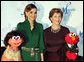 Mrs. Laura Bush stands with Her Majesty Queen Rania Al-Abdullah of Jordan and Sesame Street characters Khokha, left, and Elmo during a dinner celebrating the partnership between the Sesame Workshop and the Mosaic Foundation at the National Building Museum in Washington, D.C., Wednesday, May 9, 2006. Founded by the spouses of Arab Ambassadors to the United States, the Mosaic Foundation is dedicated to improving the lives of women and children. White House photo by Shealah Craighead