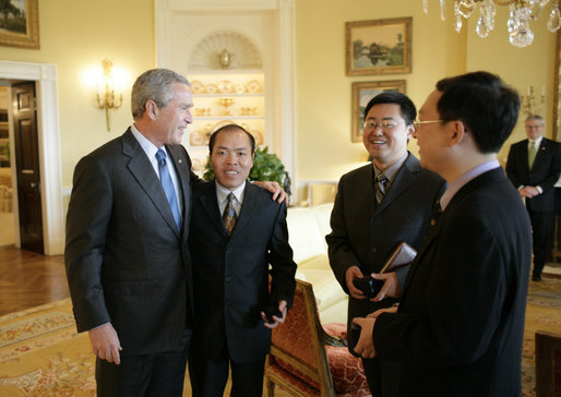 President George W. Bush meets with Chinese Human Rights activists Thursday, May 11, 2006, in the Yellow Oval Room of the White House. With the President, from left, are: Li Baiguang, Wang Yi, and Yu Jie. White House photo by Eric Draper