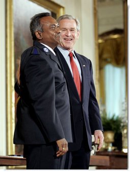 President George W. Bush and Durai Pandithurai of Cedar Hill, Texas, stand together for the presentation of the President's Volunteer Service Award in the East Room Friday, May 12, 2006. "The volunteers we recognize have brought care and outreach to veterans and men and women in uniform; they've helped children learn to read; they've extended food and shelter to hurricane victims in our Gulf Coast; they've helped underprivileged high school students prepare their SATs; and they've aided immigrants who have recently arrived in our country. They have served our nation in distinct ways, and in so doing have made America a better place to live," said the President.  White House photo by Paul Morse