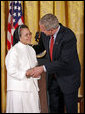 President George W. Bush awards Sister Theresa Pham of Houston with the President's Volunteer Service Award during an event celebrating Asian Pacific American Heritage Month in the East Room Friday, May 12, 2006. "I created this award because I understand the great strength of the United States of America is not found in our military, and it's certainly not because of the size of our wallets, it's because the strength of America is found in the hearts and souls of generous citizens who answer to a universal call to love a neighbor like you'd like to be loved yourself," said the President White House photo by Paul Morse
