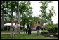 President George W. Bush and Australian Prime Minister John Howard participate in the presentation of White House trees at the Australian Ambassador's Residence, Sunday, May 14, 2006. White House photo by Eric Draper