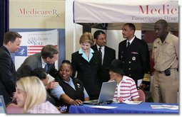 Mrs. Laura Bush meets with senior citizens during the last day of enrollment for the new Medicare prescription drug benefit at Shiloh Baptist Church in Washington, D.C., Monday, May 15, 2006. Talking with senior citizens with Mrs. Bush is Dr. Mark McClellan, Administrator, Centers of Medicare and Medicaid, and Secretary Mike Leavitt, Department of Health and Human Services. White House photo by Shealah Craighead