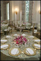 The dinner tables are set and decorated in the State Dining Room of the White House, Tuesday, May 16, 2006, for the official dinner to honor Australian Prime Minister John Howard and his wife Janette Howard. White House photo by Shealah Craighead