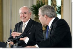 Prime Minister John Howard of Australia smiles at President Bush during their joint press conference in the East Room Tuesday, May 16, 2006. White House photo by Paul Morse