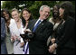 President George W. Bush laughs with members of the Sacramento Monarchs as he tries on their 2005 Women's National Basketball Association Championship ring during a congratulatory ceremony held in the East Garden at the White House Tuesday, May 16, 2006. White House photo by Eric Draper