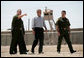 President George W. Bush tours the Yuma sector near the U.S. Mexico border led by Chief Patrol Agent Ronald Colburn, left, and Chief of the Border Patrol David Aguilar in Yuma, Arizona, Thursday, May 18, 2006. White House photo by Eric Draper