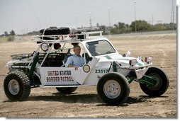 President George W. Bush rides in a U.S. Border Patrol dune buggy during a tour of the Yuma sector near the U.S. Mexico border in Yuma, Arizona, Thursday, May 18, 2006. White House photo by Eric Draper