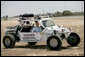President George W. Bush rides in a U.S. Border Patrol dune buggy during a tour of the Yuma sector near the U.S. Mexico border in Yuma, Arizona, Thursday, May 18, 2006. White House photo by Eric Draper