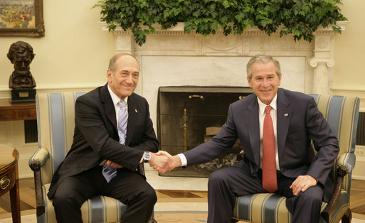 President George W. Bush exchanges handshakes with Prime Minister Ehud Olmert of Israel during their meeting Tuesday, May 23, 2006, in the Oval Office. White House photo by Eric Draper