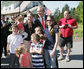 President George W. Bush poses with residents during a surprise stop in a Pottstown, Pa., neighborhood Wednesday, May 24, 2006 , after his visit to the nearby Limerick Generating Station in Limerick, Pa. White House photo by Kimberlee Hewitt