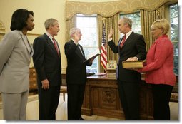 President George W. Bush is joined by Secretary of State Condoleezza Rice as Idaho Gov. Dirk Kempthorne is sworn into office as Secretary of the Interior by Chief of Staff Josh Bolten Friday, May 26, 2006. Mrs. Patricia Kempthorne holds the Kempthorne family Bible for the ceremony that was held in the Oval Office of the White House.  White House photo by Eric Draper