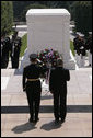 President George W. Bush stands with U.S. Army Major General Guy Swan for a moment of silence during the Memorial Day wreath laying ceremony at the Arlington National Cemetery Tomb of the Unknowns in Arlington, Va., Monday, May 29, 2006. White House photo by Paul Morse