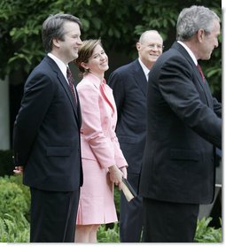 Brett and Ashley Kavanaugh and Justice Anthony Kennedy react to President George W. Bush during the Rose Garden swearing-in ceremony Thursday, June 1, 2006, for Mr. Kavanaugh to the U.S. Court of Appeals for the District of Columbia.  White House photo by Eric Draper