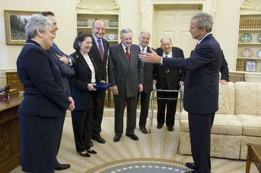 President George W. Bush talks with members of the American Society of the Italian Legions of Merit in the Oval Office on Italian Independence Day, Friday, June 2, 2006. The society representatives visited President Bush to present a Medal of Honor commemorating the 40th anniversary of their organization. The same medal was also presented Italian President Carlo Ciampi in November. Standing with the President are, from left: Dr. Aileen Sirey of Chappaqua, N.Y.; Stephen Acunto of Mt. Vernon, N.Y.; Rosemarie Gallina-Santangelo of Rye, N.Y.; Dr. Lucio Caputo of New York City; Justice Dominic Massaro of Pelham Manor, N.Y.; Larry Auriana of Greenwich, Conn.; Dominic Frinzi of Milwaukee, Wis.; and Judge Bob Messa of Feasterville, Pa. (not pictured). White House photo by Kimberlee Hewitt
