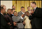 Pittsburgh Steeler Jerome Bettis, center, joins his teammates in a humorous moment with their coach Bill Cowher as the Super Bowl Champion Pittsburgh Steelers are honored at the White House, Friday, June 2, 2006, during a ceremony in the East Room. White House photo by Eric Draper