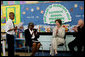Mrs. Laura Bush joins Our Lady of Perpetual Help School principal Charlene Hursey, left, and Cardinal Theodore McCarrick, Archbishop of Washington, D.C., in applauding student Marquette Lewis, 11, after his reading of the poem “Coming of Age,” Monday, June 5, 2006. Mrs. Bush visited the school to announce a Laura Bush Foundation for America’s Libraries grant to Our Lady of Perpetual Help School. White House photo by Shealah Craighead