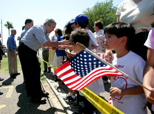 President George W. Bush greets a crowd during an unscheduled stop at a Laredo, Texas, elementary school after visiting the Laredo Border Patrol Sector Headquarters, Tuesday, June 6, 2006. White House photo by Eric Draper
