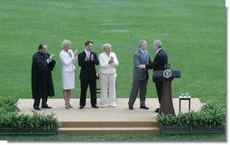 President George W. Bush congratulates former Idaho Gov. Dirk Kempthorne, as Kempthorne’s family and Supreme Court Justice Antonin Scalia, left, applaud following the swearing-in ceremony for Kempthorne as the new U.S. Secretary of Interior, Wednesday, June 7, 2006 on the South Lawn of the White House in Washington.  White House photo by David Bohrer