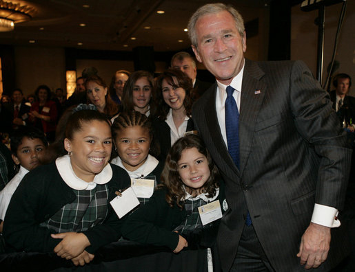 President George W. Bush poses with a group of young children Thursday morning, June 8, 2006, following his address at the National Hispanic Prayer Breakfast in Washington. White House photo by Kimberlee Hewitt