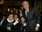 President George W. Bush poses with a group of young children Thursday morning, June 8, 2006, following his address at the National Hispanic Prayer Breakfast in Washington. White House photo by Kimberlee Hewitt