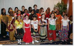 Mrs. Laura Bush poses with members of the St. Catherine Laboure School’s Cultural Hertiage Choir, Thursday, June 8, 2006 at the President’s Malaria Initiative conference at the National Press Club in Washington. The choir, dressed in heritage costumes, consists of students from first grade to eighth grade representing 20 nations.  White House photo by Shealah Craighead