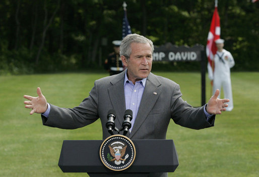 President George W. Bush gestures as he answers a reporter's question during his joint news conference with Prime Minister Anders Fogh Rasmussen of Denmark at Camp David Friday, June 9, 2006. White House photo by Eric Draper