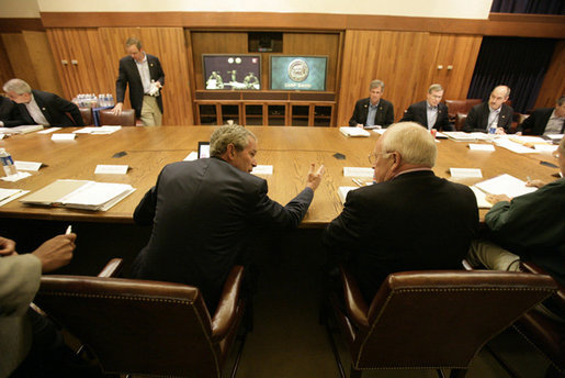 President George W. Bush speaks with his top advisors during a meeting Monday, June 12, 2006 at Camp David, Md., part of a two-day conference on Iraq. White House photo by Eric Draper