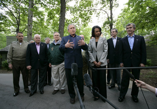 President George W. Bush, surrounded by members of his Cabinet and his national security team, talks with reporters Monday afternoon, June 12, 2006 in Camp David, Md., during the first day of a two-day meeting on Iraq. President Bush is joined by, from left to right, Chairman of the Joint Cheifs of Staff General Peter Pace, Vice President Dick Cheney, Secretary of Defense Donald Rumsfeld, Secretary of State Condoleezza Rice, Secretary of Commerce Carlos Gutierrez and Secretary of Agriculture Mike Johanns. White House photo by Eric Draper