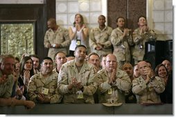 U.S. troops listen to President George W. Bush speak during his an 5-hour trip to Baghdad, Iraq, Tuesday, June 13, 2006. "I have come today to personally show our nation's commitment to a free Iraq. My message to the Iraqi people is this: seize the moment; seize this opportunity to develop a government of and by and for the people. And I also have a message to the Iraqi people that when America gives a commitment, America will keep its commitment." White House photo by Eric Draper