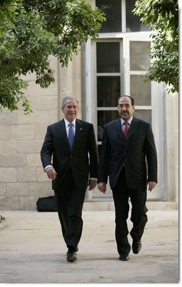 President George W. Bush walks with Prime Minister Nouri al-Maliki Tuesday, June 13, 2006, at the U.S. Embassy in Baghdad, Iraq. During his unannounced trip to Iraq, President Bush thanked the Prime Minister, telling him, "I'm convinced you will succeed, and so will the world."  White House photo by Eric Draper