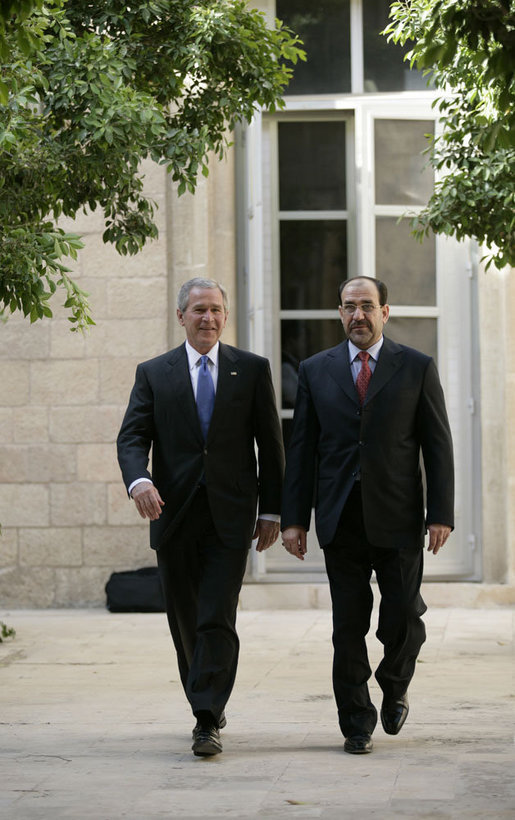 President George W. Bush walks with Prime Minister Nouri al-Maliki Tuesday, June 13, 2006, at the U.S. Embassy in Baghdad, Iraq. During his unannounced trip to Iraq, President Bush thanked the Prime Minister, telling him, "I'm convinced you will succeed, and so will the world." White House photo by Eric Draper