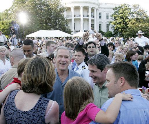 President George W. Bush welcomes guests to the annual Congressional Picnic on the South Lawn of the White House Wednesday evening, June 15, 2006, hosting members of Congress and their families to a "Rodeo" theme picnic. White House photo by Paul Morse
