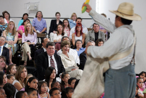 Mrs. Laura Bush watches Ricardo Araiza, one of the two actors, perform in the Childsplay production of Tomás and the Library Lady, at the Boys and Girls Club of the East Valley in Guadalupe, Arizona. The play promotes literacy and encourages young people to look past the confines of poverty, language barriers and cultural intolerance to find joy in reading. White House photo by Shealah Craighead
