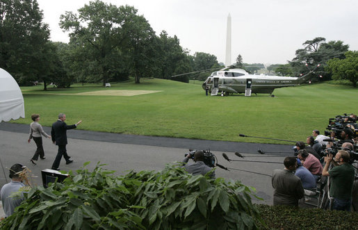President George W. Bush and Laura Bush wave as they head to Marine One on the South Lawn of the White House Tuesday, June 20, 2006, en route to Vienna where the President will meet with European Union leaders before traveling on to Budapest. White House photo by Kimberlee Hewitt