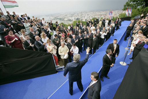 President George W. Bush waves after delivering remarks at Gellert Hill in Budapest, Hungary, Thursday, June 22, 2006. "The Hungarian people know well the promise of freedom. Many of you lived through the nightmare of fascism, or communism, or both. Yet you never lost hope. You kept faith in freedom," said the President. "And 50 years after you watched Soviet tanks invade your beloved city, you now watch your grandchildren play in the streets of a free Hungary." White House photo by Eric Draper