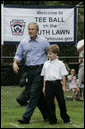 President George W. Bush joins Zane Ellingwood, the First Ball Presenter, on the South Lawn of the White House at the opening game of the 2006 Tee Ball season, Friday, June 23, 2006, between the McGuire Air Force Base Little League Yankees and the Dolcom Little League Indians of the Naval Submarine Base from Groton, Ct. White House photo by Paul Morse