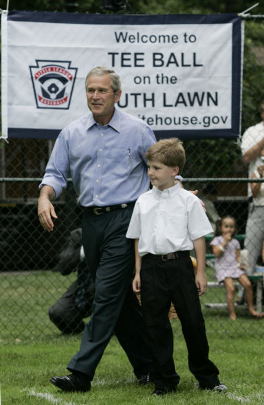 President George W. Bush joins Zane Ellingwood, the First Ball Presenter, on the South Lawn of the White House at the opening game of the 2006 Tee Ball season, Friday, June 23, 2006, between the McGuire Air Force Base Little League Yankees and the Dolcom Little League Indians of the Naval Submarine Base from Groton, Ct. White House photo by Paul Morse
