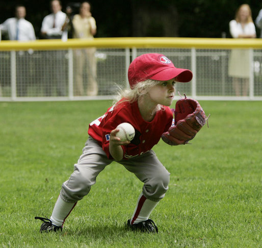 A member of the McGuire AFB Little League Yankees team fields the ball on the South Lawn of the White House during the opening game of the 2006 Tee Ball season, Friday, June 23, 2006, between the McGuire AFB Yankees and the Dolcom Little League Indians of the Naval Submarine Base from Groton, Ct. White House photo by Paul Morse