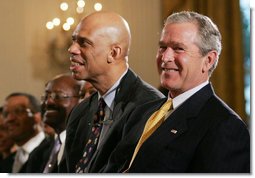 President George W. Bush is joined by basketball Hall of Famer Kareem Abdul Jabbar in the East Room of the White House Monday, June 26, 2006, as they listen to performer Patti Austin at the Black Music Month celebration focusing on the music of the Gulf Coast: Blues, Jazz and Soul.  White House photo by Eric Draper