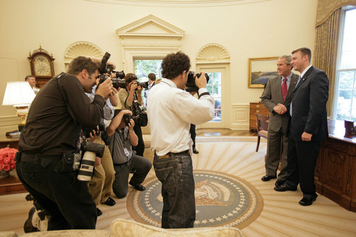 President George W. Bush meets with U.S. Army Staff Sergeant Christian Bagge, 23, of Eugene, Ore., in the Oval Office Tuesday, June 27, 2006. Mr. Bagge lost both legs to a roadside bomb in Iraq while serving in Operation Iraqi Freedom. After their meeting, the two ran together on the South lawn. White House photo by Eric Draper