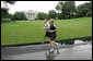 President George W. Bush runs with U.S. Army Staff Sergeant Christian Bagge, 23, of Eugene, Ore., on the South Lawn Tuesday, June 27, 2006. President Bush met Sgt. Bagge at Brooke Army Medical Center Jan. 1, 2006, where he promised to run with Sgt. Bagge. Since then, Sgt. Bagge has reenlisted to active duty. White House photo by Eric Draper