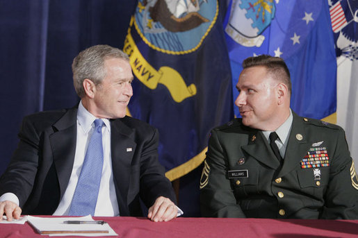 President George W. Bush talks with U.S. Army Sgt. First Class Kenneth Williams, as he meets with military personnel Wednesday, June 28, 2006, at the VFW Overland-St. Ann Memorial Post #3944 in St. Louis, Mo., who recently have returned from Iraq and Afghanistan. White House Photo by Kimberlee Hewitt White House photo by Kimberlee Hewitt