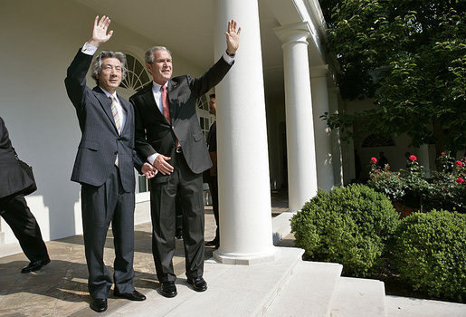 President George W. Bush and Prime Minister Junichiro Koizumi of Japan wave from the steps of the Rose Garden before meeting in the Oval Office Thursday, June 29, 2006 White House photo by Eric Draper